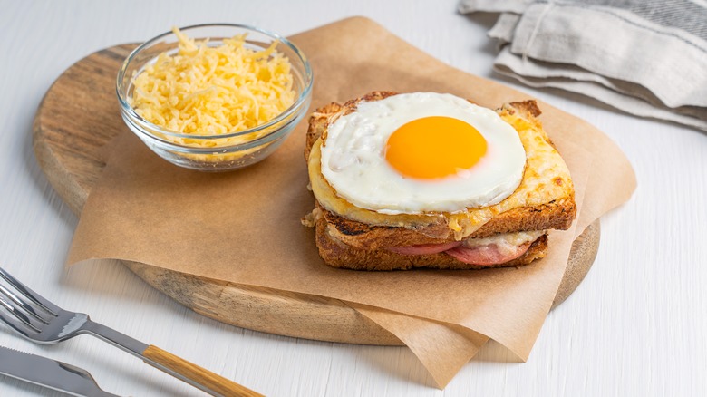 croque madame and cheese on parchment paper