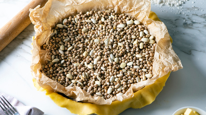 pie crust filled with parchment paper and dried beans