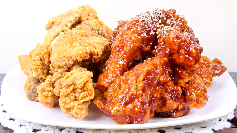 a plate of Korean fried chicken without and with sauce