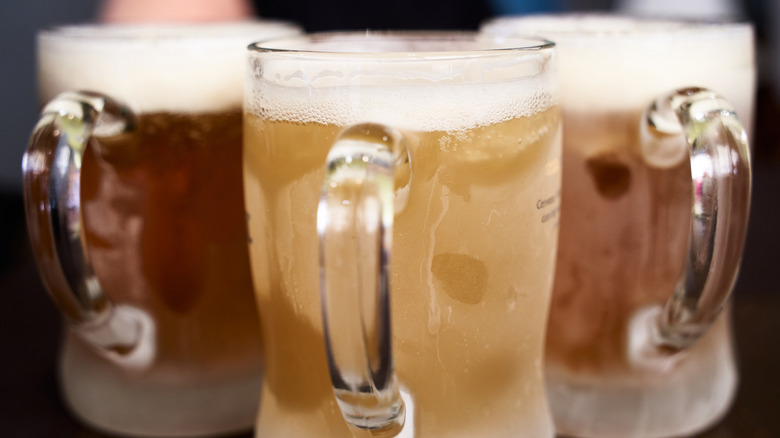 Trio of filled frosted beer mugs