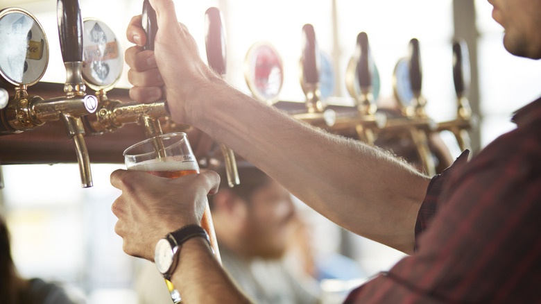 Bartender pulling a pint at a bar