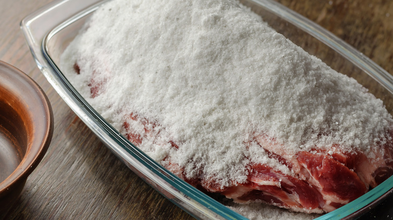 Curing meat with salt