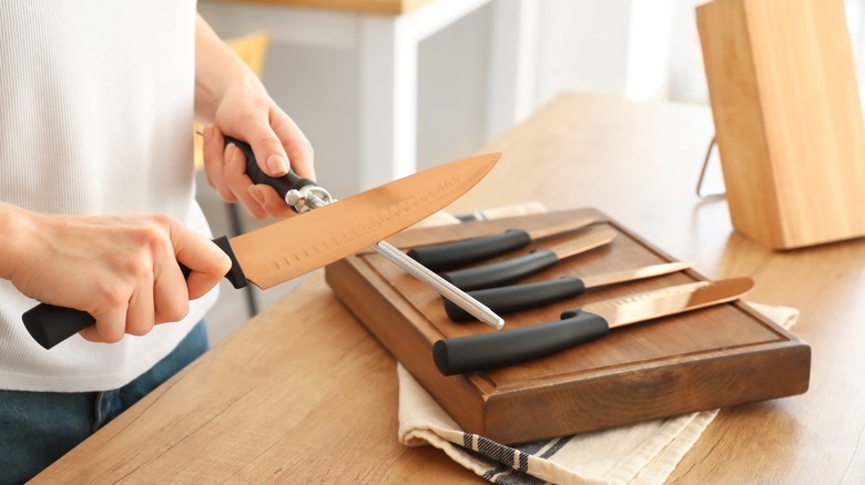 Woman sharpening knife 