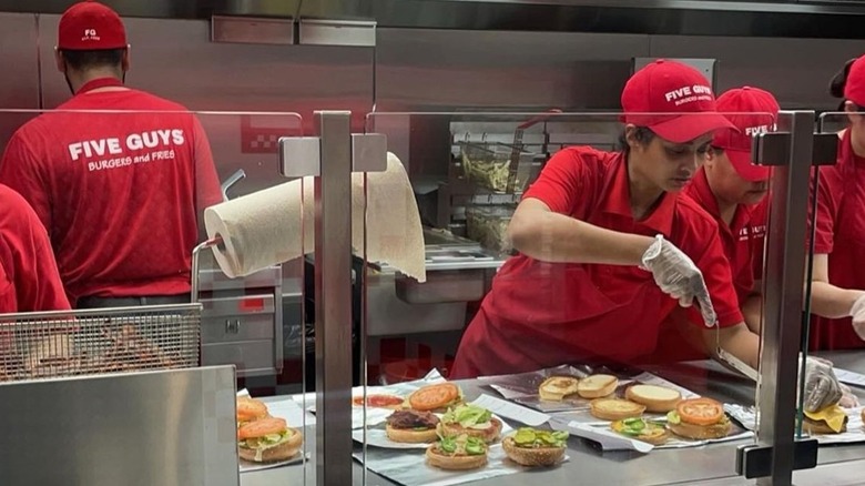 Workers on the line at a Five Guys