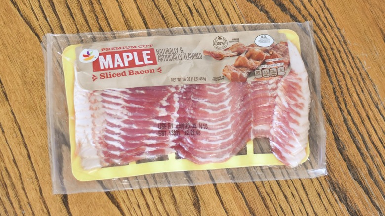 A package of Giant premium cut maple sliced bacon on a wooden table