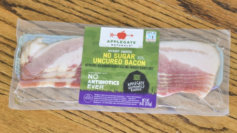 A package of Applegate Naturals uncured bacon on a wooden table