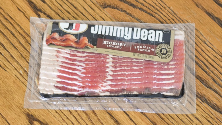 A package of Jimmy Dean hickory smoked bacon on a wooden table