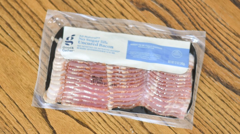 A package of Good & Gather uncured bacon on a wooden table