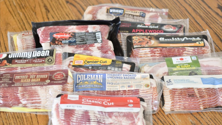 A grouping of bacon packages on a wooden table