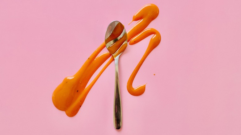 Spoon covered in Buffalo sauce