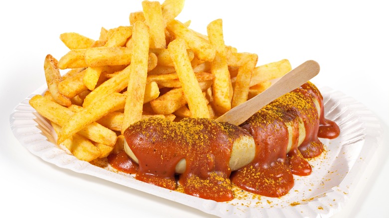 Curry ketchup lathered over bratwurst with a side of fries