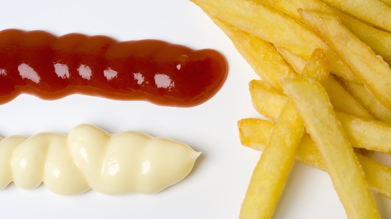 Mayo and ketchup on a plate with fries