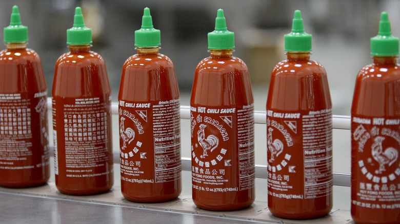 Bottles of sriracha lined up