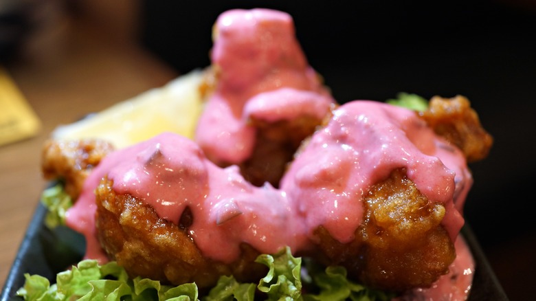 Pink tartar sauce on fried tuna