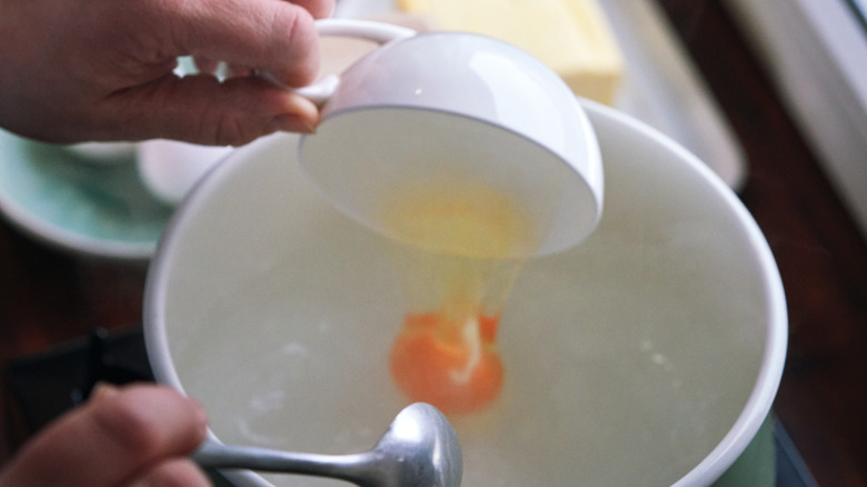 Dropping an egg into water