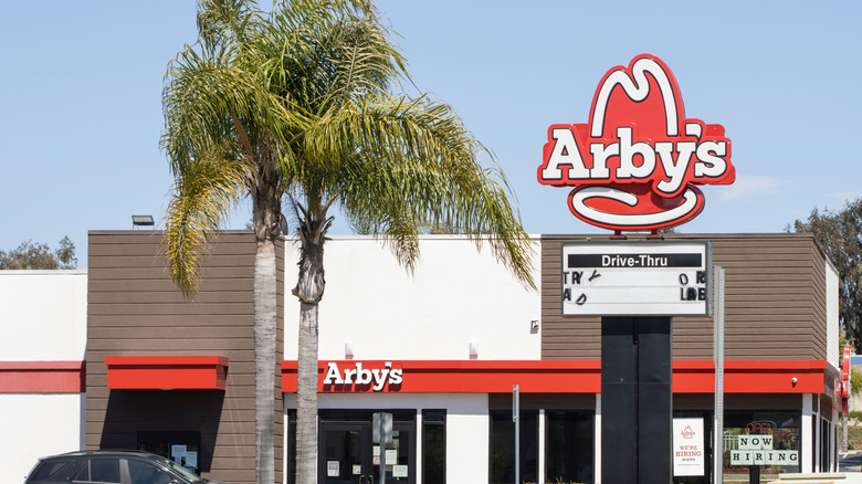 Arby's drive-thru and Arby's sign with a blue sky background