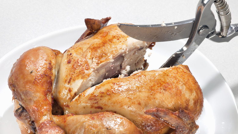 Whole roasted chicken and kitchen shears