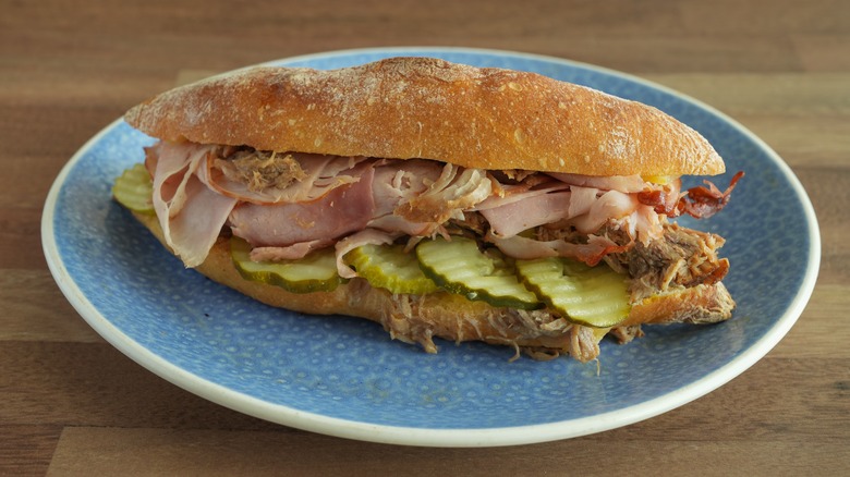 A Cubano sandwich on a blue plate