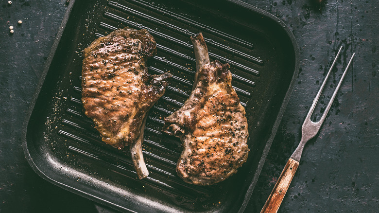Two pork chops in a grill pan