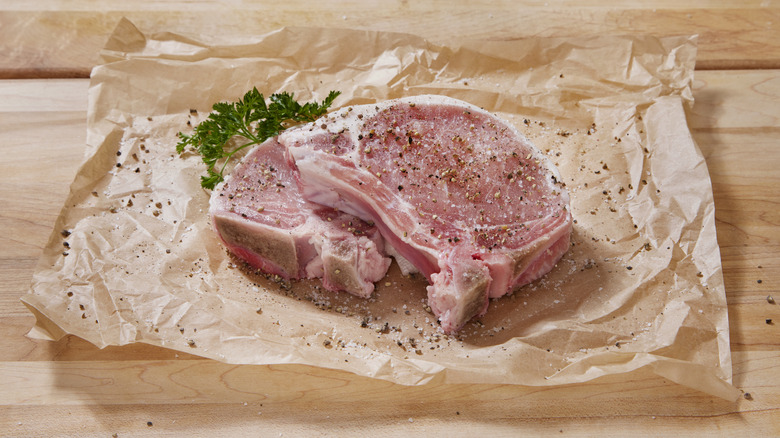 A raw pork chop on butcher's paper