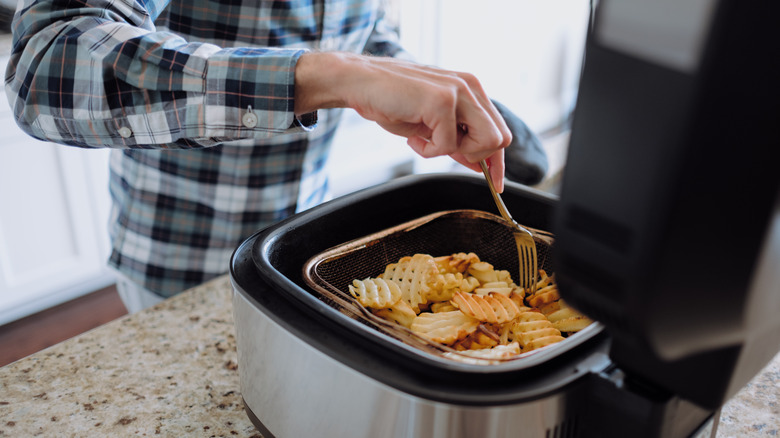 Man using air-fryer cooking