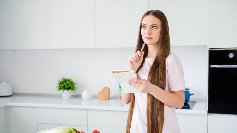 Woman pondering to-do list