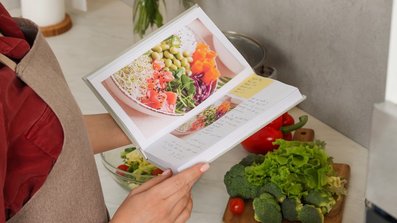 Woman reading recipe cookbook