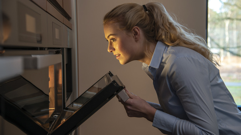 Woman looking into oven