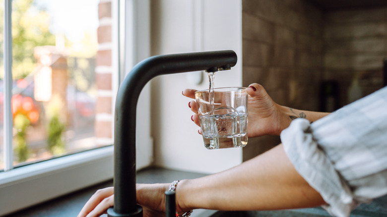 Woman pouring water into glass