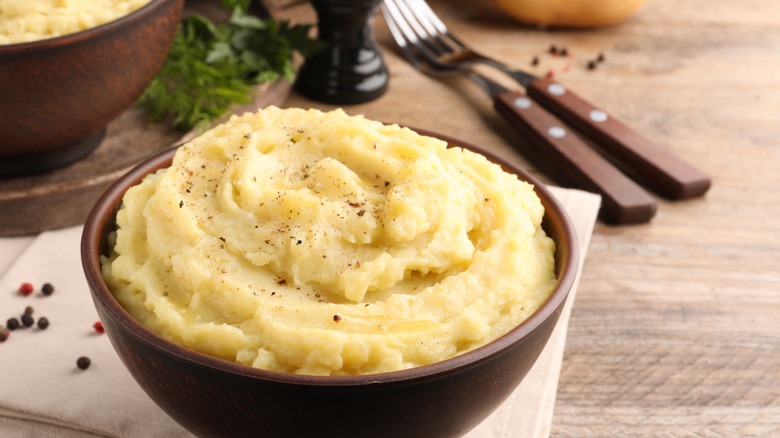 Bowl of mashed potatoes with cutlery