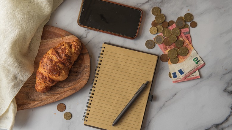 Croissant, phone, notebook