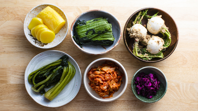 six small bowls of japanese pickled foods