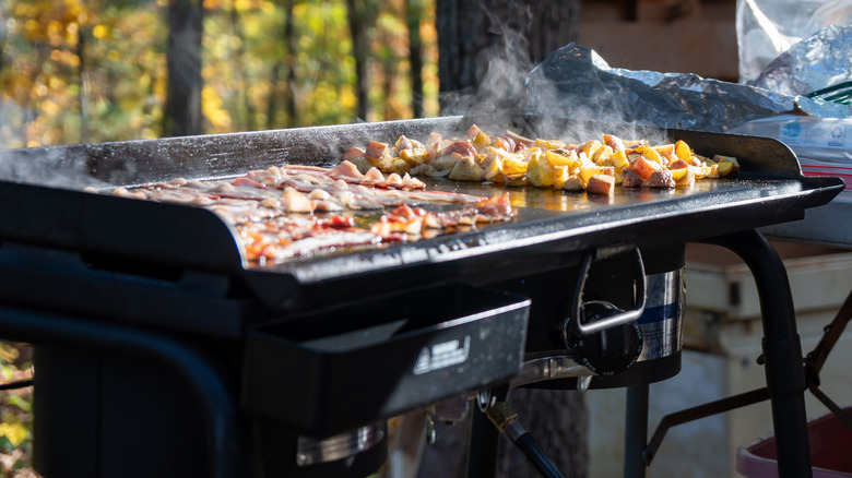 Breakfast food cooking on griddle