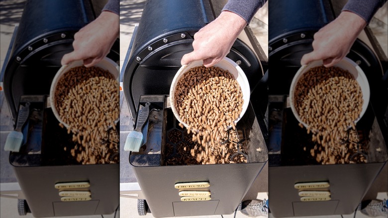 Pouring wood pellets into grill