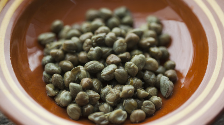Capers in a brown bowl