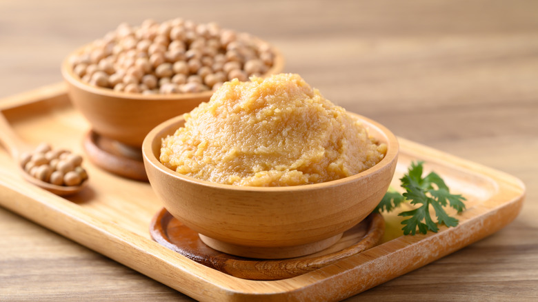 Bowl of miso paste with bowl of soybeans
