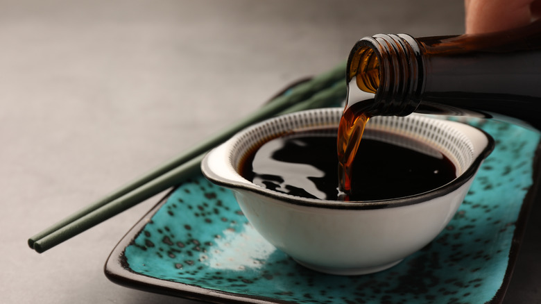 Soy sauce being poured into small bowl