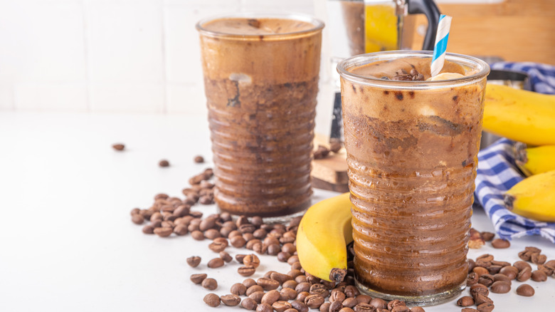 coffee beans scattered around coffee banana protein shakes