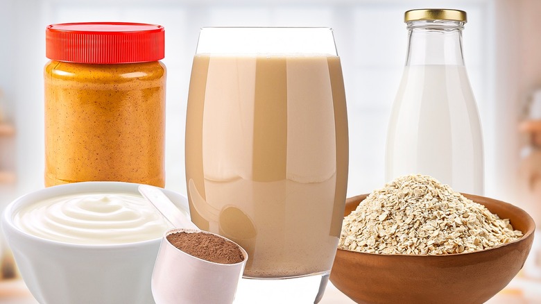 a protein shake sits beside a scoop of powder, bowl of oats, and other possible additions