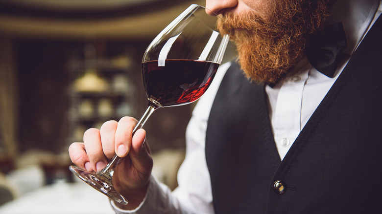 Bearded man holding wine glass