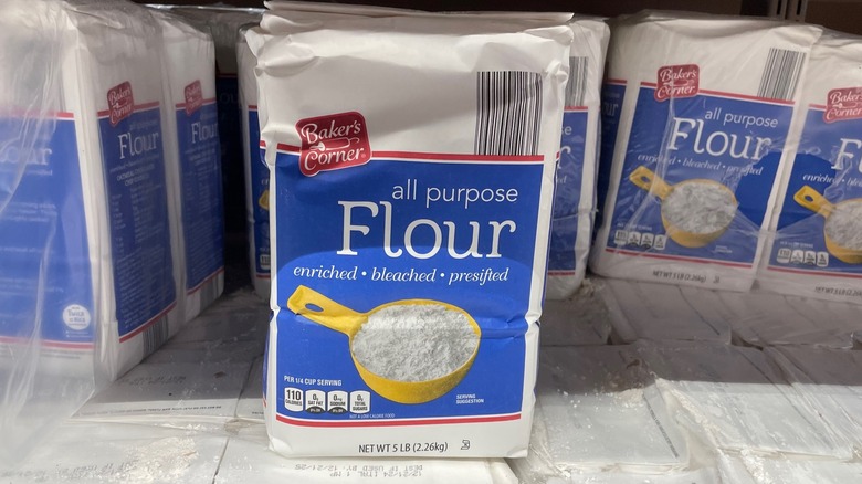 A bag of Aldi flour sits on the store shelf.