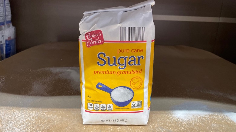 A bag of Aldi sugar sits on the store shelf.