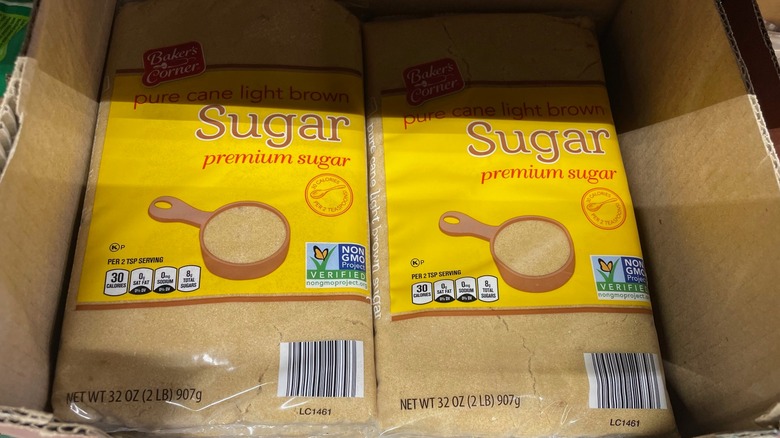 Two bags of Aldi brown sugar sit in a display box at the store.