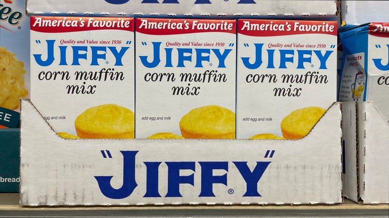 Three boxes of Jiffy corn muffin mix sit in the display box at the store.