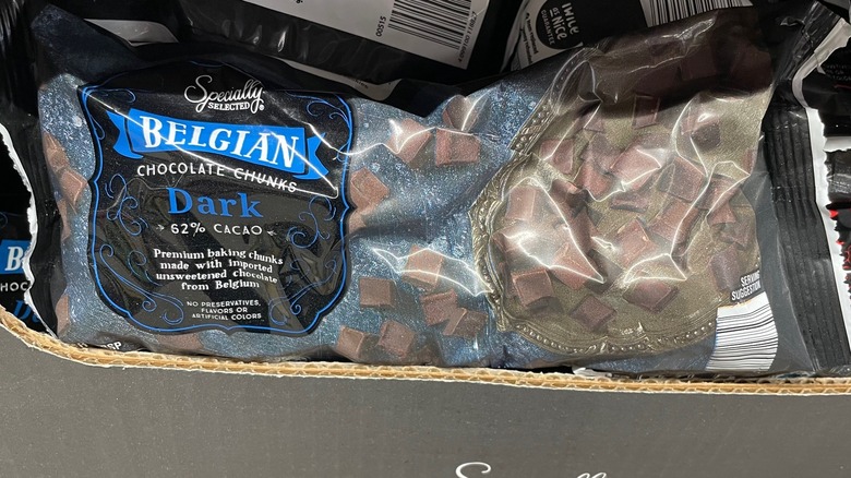 A bag of Aldi specialty chocolate chunks is in the display box at the store.