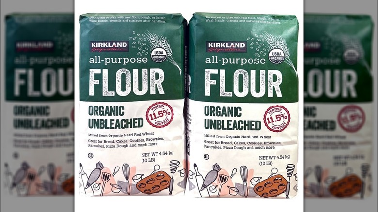 Two bags of Kirkland Signature all-purpose flour side by side on a white background