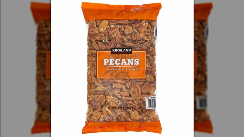 A bag of Kirkland Signature pecans on a white background