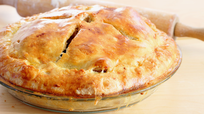 Pie with golden crust on counter top