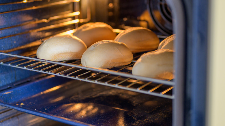 Loaves of bread baking in over with tray below