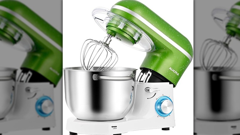 Green and white Aucma mixer with head tilted back and whisk attatched